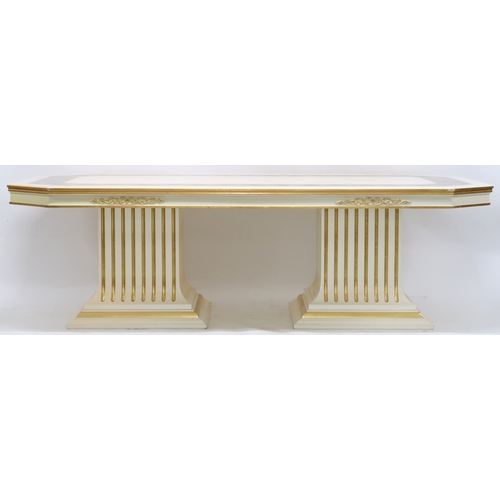2085 - A CONTEMPORARY VERSACE DINING SUITE consisting of gilt white dining table on twin fluted square pede... 
