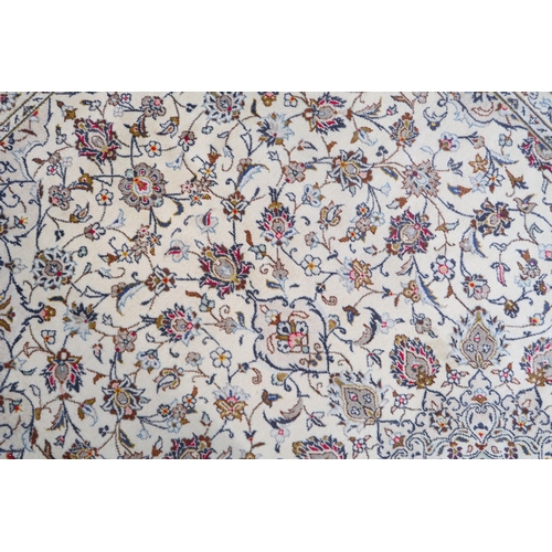 2130 - A CREAM GROUND KASHAN RUGwith flower head central medallion, matching spandrels and flower head bord... 