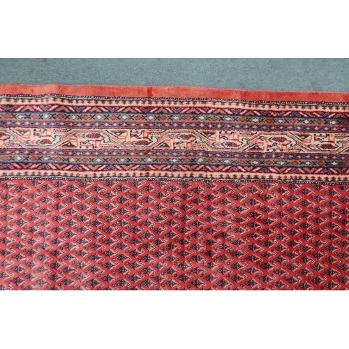 2133 - A RED GROUND ARDABIL RUGwith multicoloured geometric borders, 312cm long x 215cm wide... 