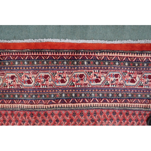 2133 - A RED GROUND ARDABIL RUGwith multicoloured geometric borders, 312cm long x 215cm wide... 
