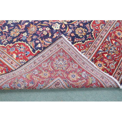 2134 - A DARK BLUE GROUND KASHAN RUGWith red and cream diamond central medallion and matching spandrels on ... 