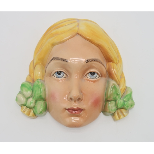 2184 - A BESWICK POTTERY 1930S ART DECO FACE MASKmodelled as a girl with curly brown hair,  green beret and... 