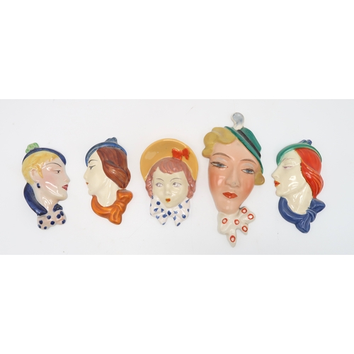 2189 - A COLLECTION OF CZECHOSLOVAKIAN ART DECO WALL MASKSmodelled as female heads with painted decoration,... 