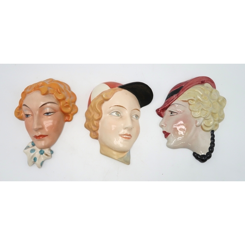 2194 - A COLLECTION OF CZECHOSLOVAKIAN AND OTHER ART DECO WALL MASKSone of a man in a cap smoking a pipe, t... 