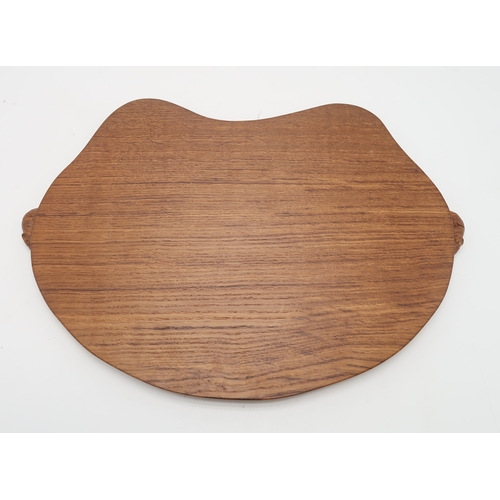 2200 - ROBERT MOUSEMAN THOMPSON (1876-1955)An oak kidney shaped tea tray, with twin carved mouse signature ... 