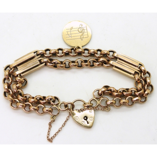 2733 - A VINTAGE BRACELETwith facet cut round links and double baton links a heart shaped clasp and medalli... 