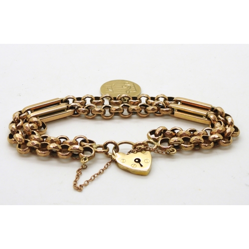 2733 - A VINTAGE BRACELETwith facet cut round links and double baton links a heart shaped clasp and medalli... 