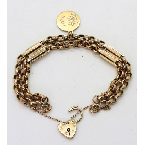 2733 - A VINTAGE BRACELETwith facet cut round links and double baton links a heart shaped clasp and medalli... 