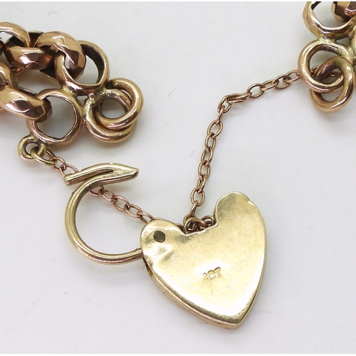 2733 - A VINTAGE BRACELETwith facet cut round links and double baton links a heart shaped clasp and medalli... 