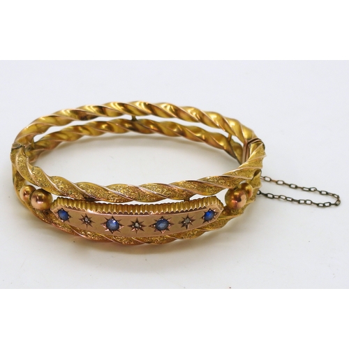 2734 - A 9CT EDWARDIAN BANGLEset with blue gems and rose cut diamond accents to the double barley twist ban... 