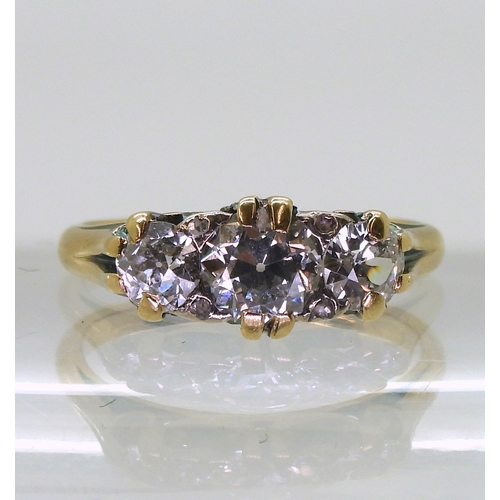 2736 - A SCROLL MOUNTED DIAMOND RINGthe bright yellow mount set with three old cut diamonds, with an estima... 