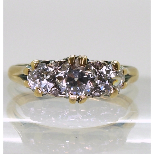 2736 - A SCROLL MOUNTED DIAMOND RINGthe bright yellow mount set with three old cut diamonds, with an estima... 