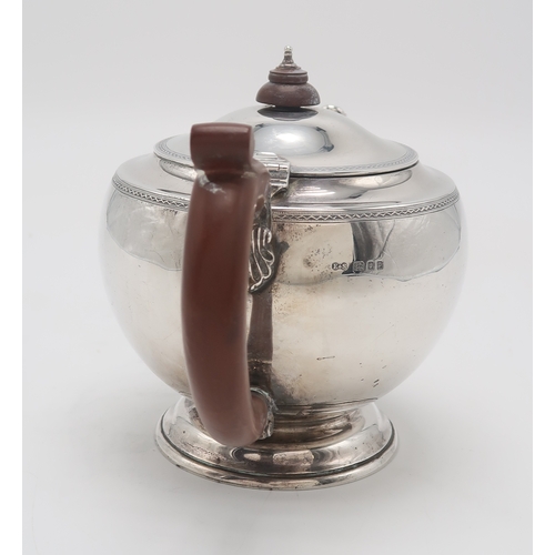 2473 - A GEORGE V SILVER TEAPOTby Edwards & Sons, London 1930, of compressed circular form, with engine... 