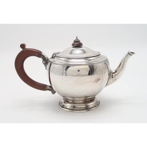 2473 - A GEORGE V SILVER TEAPOTby Edwards & Sons, London 1930, of compressed circular form, with engine... 