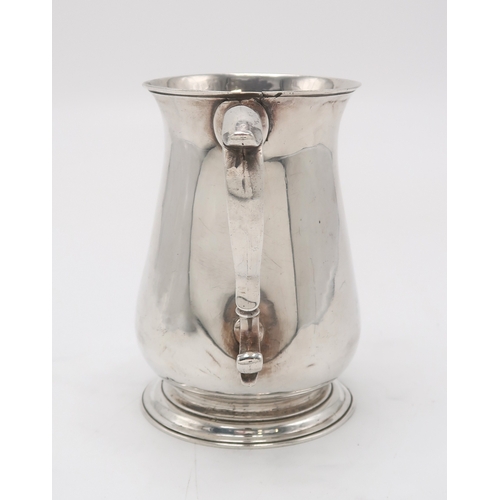 2477 - A GEORGE II SILVER TANKARDLondon 1757, maker's mark rubbed, of plain baluster form, with a scrolling... 