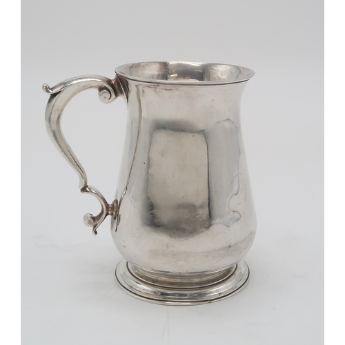 2477 - A GEORGE II SILVER TANKARDLondon 1757, maker's mark rubbed, of plain baluster form, with a scrolling... 