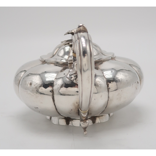 2481 - A WILLIAM IV SILVER TEAPOTby Charles Gordon, London 1833, of compressed melon form, with a floral fi... 