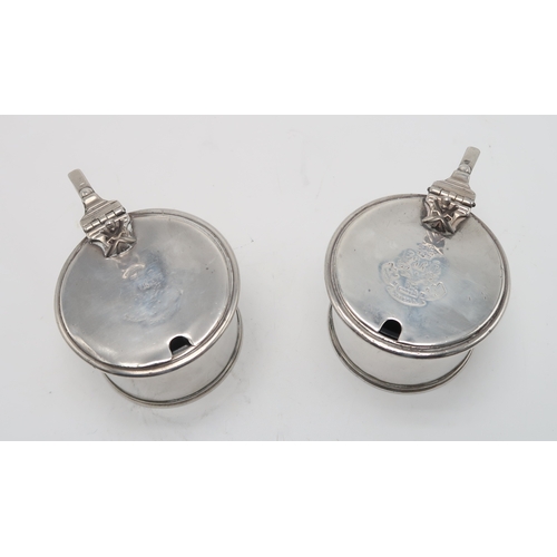 2493 - MILITARY INTEREST;A pair of Victorian silver mustard pots, by Samuel Whitford, London 1870, of circu... 