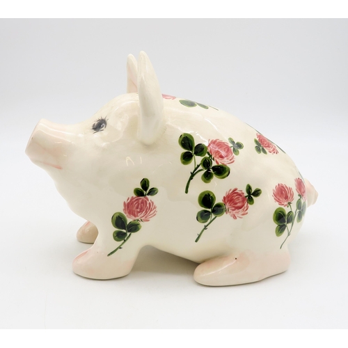 183 - A Griselda Hill pottery pig painted with clover, 12cm high