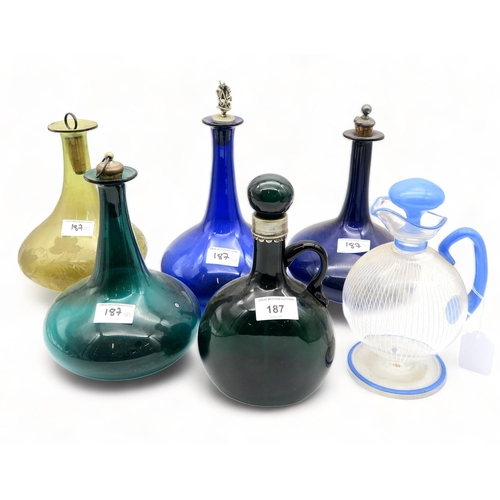 187 - Four coloured glass wine bottles, together with two other decanters