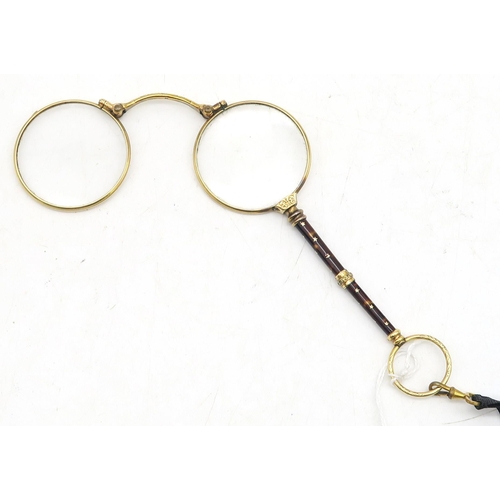 539 - A pair of gilt metal lorgnettes, with sprung release mechanism 