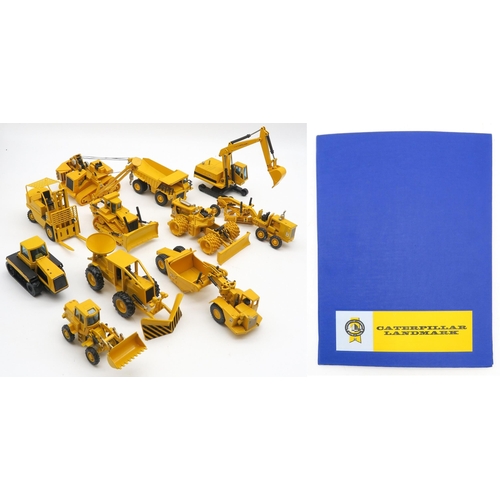 569 - A collection of Caterpillar die-cast model vehicles, together with a copy of Caterpillar Landmark... 