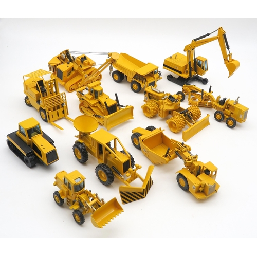 569 - A collection of Caterpillar die-cast model vehicles, together with a copy of Caterpillar Landmark... 