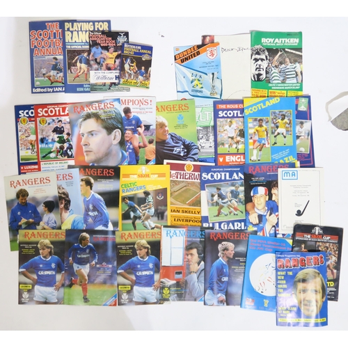 570 - A large collection of 1980s-era Rangers and Celtic F.C. football programmes and related ephemera, in... 