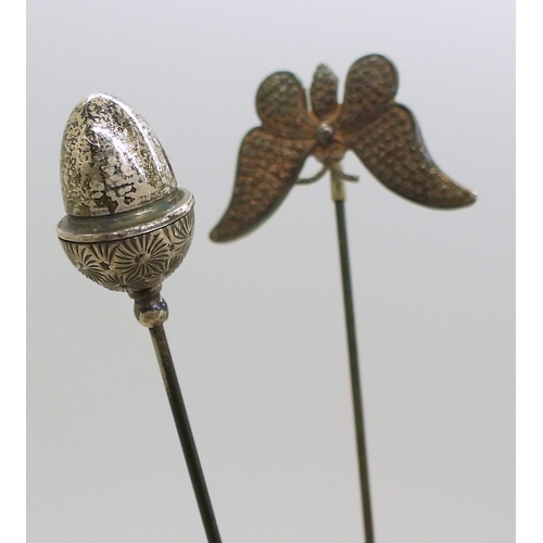 814 - A large collection of hatpins to include a detailed brass bird with gem set eye, Czech glass example... 