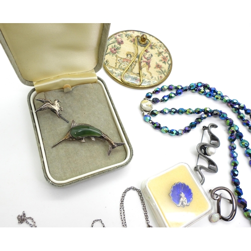 843 - A collection of silver and costume jewellery to include peacock beads, a silver Canadian green hards... 