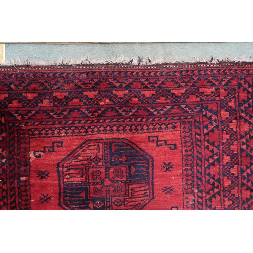 109 - A red ground Bokhara rug with four octagonal medallions within multiple borders, 205cm long x 134cm ... 