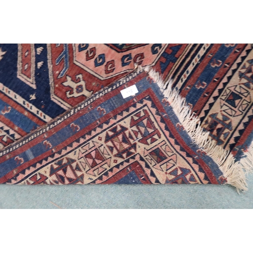 110 - A dark blue ground Balouch rug with geometric patterned ground within multicoloured border, 158cm lo... 