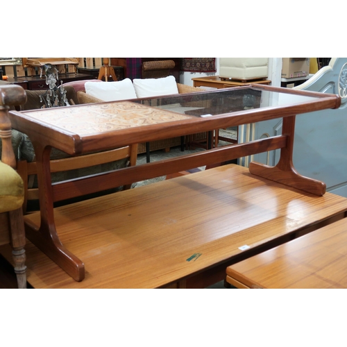 63 - A mid 20th century teak and glass coffee table with tile inset top on shaped supports joined by stre... 