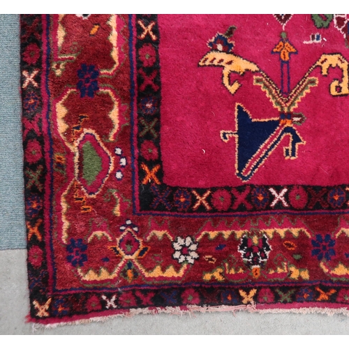 71 - A plum ground Balouch rug with dark blue central medallion and multicoloured border, 264cm long x 18... 