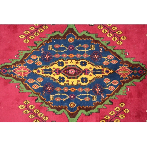 71 - A plum ground Balouch rug with dark blue central medallion and multicoloured border, 264cm long x 18... 