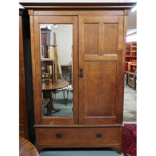 97 - A late Victorian oak Arts & Crafts wardrobe with moulded cornice over mirrored door alongside pa... 