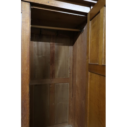 97 - A late Victorian oak Arts & Crafts wardrobe with moulded cornice over mirrored door alongside pa... 