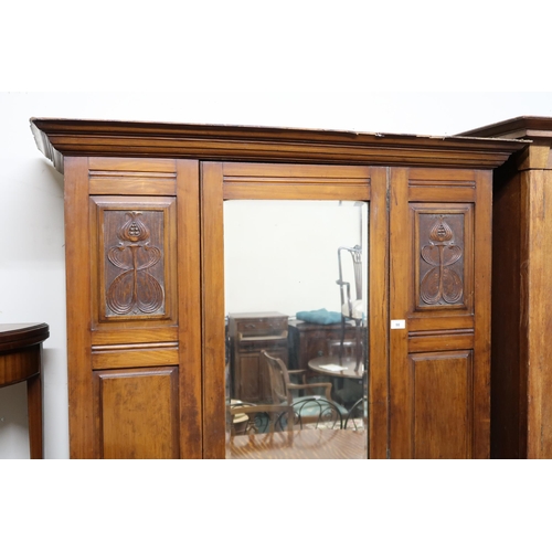 98 - An early 20th century mahogany Arts & Crafts wardrobe with moulded cornice over single mirror do... 