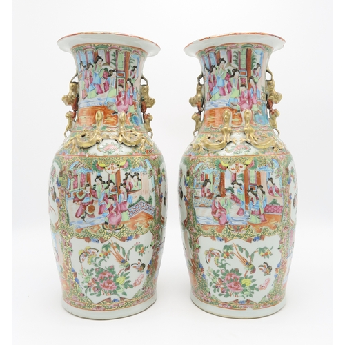 2362 - A PAIR OF CANTON BALUSTER VASESPainted with panels of figures, birds, insects and foliage, within gi... 