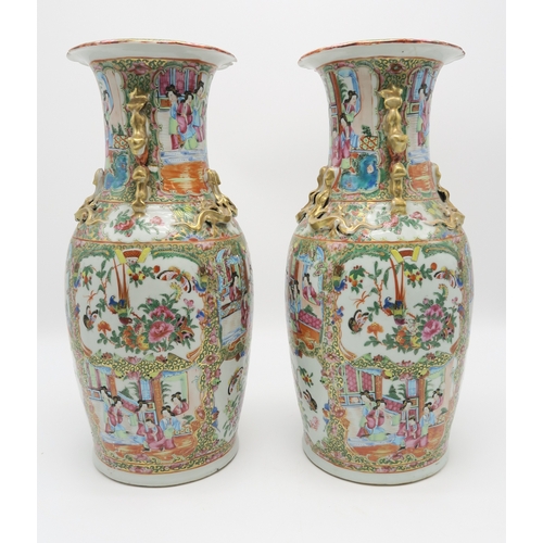 2362 - A PAIR OF CANTON BALUSTER VASESPainted with panels of figures, birds, insects and foliage, within gi... 