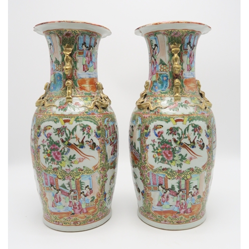 2362 - A PAIR OF CANTON BALUSTER VASESPainted with panels of figures, birds, insects and foliage, within gi... 