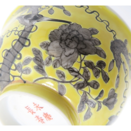 2367 - THREE CHINESE YELLOW GROUND BOWLSPainted with birds amongst scattered flowers and tendrils, gilt sea... 