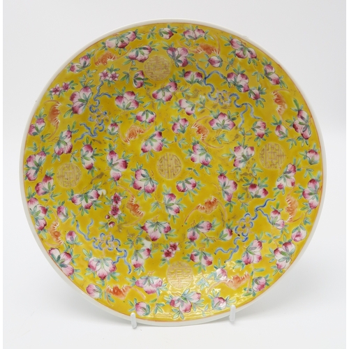 2369 - A CHINESE YELLOW GROUND DISH Painted with bats and peaches,divided by gilt shou characters,red seal ... 