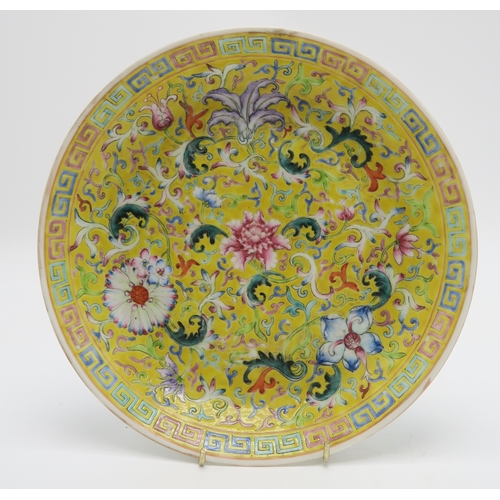 2369 - A CHINESE YELLOW GROUND DISH Painted with bats and peaches,divided by gilt shou characters,red seal ... 