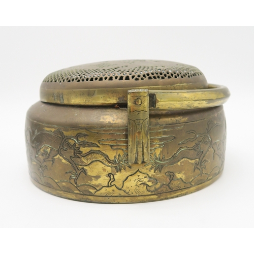 2377 - A CHINESE BRASS HAND WARMERDecorated with dragons and foliage, swing handle, 26cm diameter and anoth... 