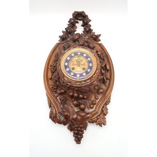 2216 - A 19TH CENTURY BLACK FOREST WALL CLOCKcarved profusely with fruits, flowers and foliage, the gilded ... 