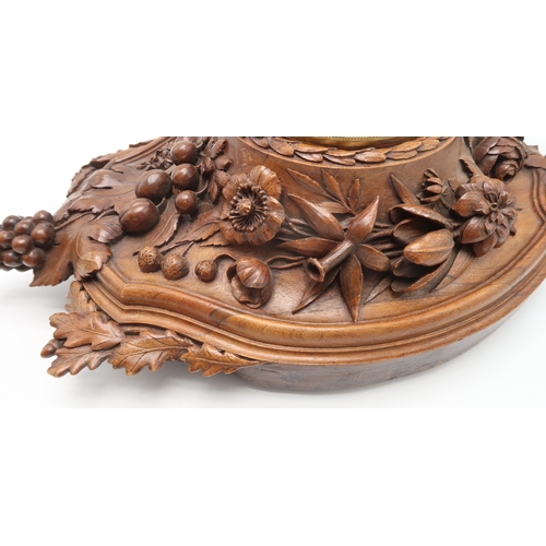 2216 - A 19TH CENTURY BLACK FOREST WALL CLOCKcarved profusely with fruits, flowers and foliage, the gilded ... 