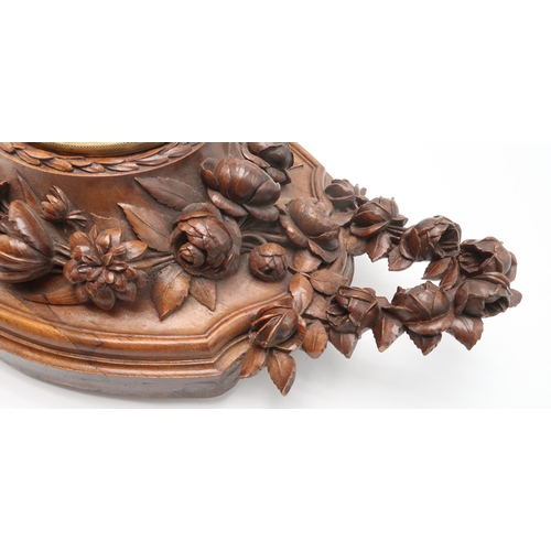 2216 - A 19TH CENTURY BLACK FOREST WALL CLOCKcarved profusely with fruits, flowers and foliage, the gilded ... 