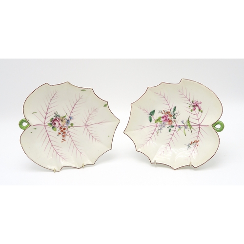 2218 - A NEAR PAIR OF CHELSEA LEAF SHAPED DISHESeach with painted puce veined detail and floral bouquets, t... 