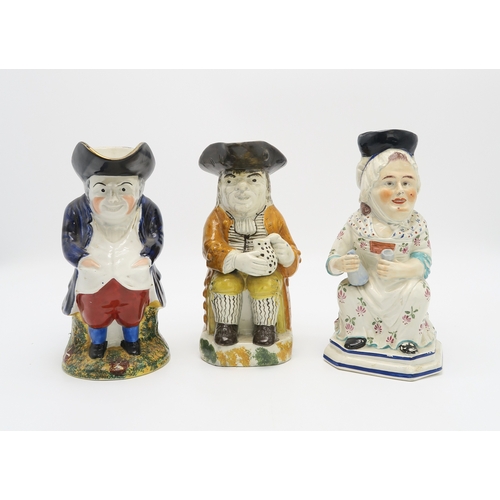 2222 - A STAFFORDSHIRE 18TH CENTURY TOBY JUGmodelled sitting holding a jug, his cloak of an ochre colour, t... 